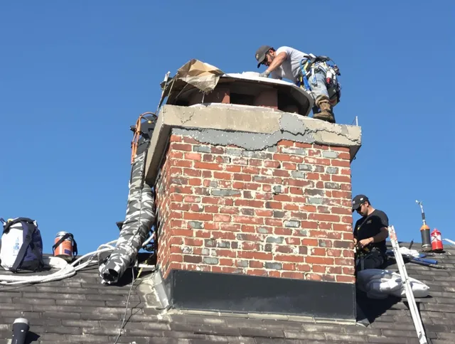 Monroe Chimney Sweep installing a custom chimney crown in Monroe, NC